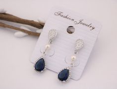 "Navy Blue Sapphire Blue Bridesmaid Earrings, Dark Blue Earrings, Bridesmaid Gift, Navy Wedding, Bridesmaid Jewelry, Bridal Jewelry This vintage inspired stunning Pearl and Cubic Zirconia earring is beautiful addition to your wedding day. Earrings size Measures: 1.75\" x 0.5 \" nickel-free post backing. Tone color: - Sliver tone Pearl color : -- Swarovski white pearl -- Swarovski ivory pearl -- Fresh water pearl Crystal Color : - # 1 Champagne Color - # 2 Crystal Rainbow Dark Blue Color - # 3 Bl Blue Teardrop Pearl Earrings For Wedding, Blue Pearl Drop Bridal Earrings For Wedding, Sapphire Earrings For Wedding, Wedding Day Earrings, Blue Wedding Earrings, Wedding Earrings Pearl, Blue Earrings Wedding, Blue Wedding Hair, Blue Bridal Earrings