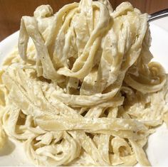 a white plate topped with pasta covered in sauce