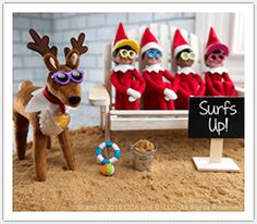 three elfs are sitting in the sand near a sign that says north pole vacation spot