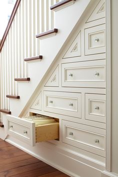 an image of a staircase with drawers under the banister and underneath the stair railing