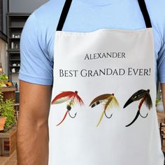 a man wearing an apron with three different types of flies printed on it, and the words best grandad ever