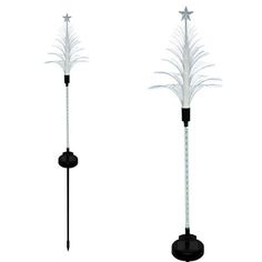 two tall white feathered poles with stars on top and one black pole in the middle