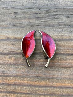 These beautifully made clip on earrings are marked, 'DA 925 Sterling Norway' on the back; the 'DA' standing for David Andersen. The leaves have rich red enamel with light veins and a glossy finish. The metal has a gold color and can be polished more if desired. Each earring measures 1 1/4 inches long. Red Enamel Clip-on Jewelry, Red Enamel Clip-on Earrings, Red Enamel Earrings For Anniversary, Mosaic Inlay, Owl Ring, Bird Pins, Silver Owl, Pink Moon, Fall Leaf