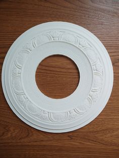 a white circular object sitting on top of a wooden table