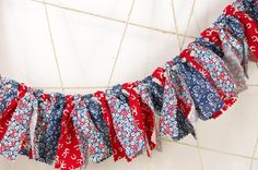 a red, white and blue fabric garland hanging on a wall