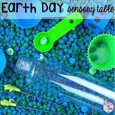 an earth day activity with plastic cups, spoons and other items on the ground