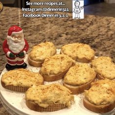 there are many mini pies on the plate with santa clause figurine next to them