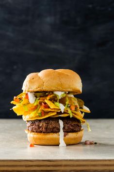 a hamburger with lettuce, cheese and other toppings