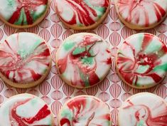 many decorated cookies on a red and white paper