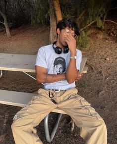 a man with headphones sitting on a bench