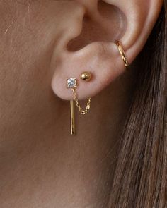 You save $120 and get free shipping with this set. The combinations are endless with this Earring Capsule. This set includes all 8 original essentials designs: Arc ear jackets Chain ear jackets (small) Circle hoop ear jackets Bar ear jackets Ball stud earrings Emerald stud earrings Solitaire stud earrings Stripe stud earrings Handcrafted in 14K gold vermeil - a thick 14K gold layer on sterling silver Emerald cut earrings and solitaire stud earrings are set with premium, lab-created cubic zirconi Classy Ear Piercings Chic, Double Ear Piercing Ideas Simple, Third Piercing Ideas, Multiple Earrings Inspiration, Three Piercings Ears, Earring Set Ideas, Second Ear Piercing Ideas, Ear Piercings Chain, Gold Double Earrings