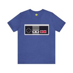 Step back into the golden age of gaming with our vintage NES controller short sleeve t-shirt. The iconic NES controller design on this tee is a true nostalgia trip for gamers of all ages. Relive your favorite gaming memories with this retro video game tee. Whether you're a seasoned gamer or just love the classic look, this shirt is a must-have addition to your collection. Level up your style with this NES controller t-shirt and show the world your love for classic gaming. It's not just a shirt; it's a piece of gaming history. Graphic Print Crew Neck T-shirt For Gaming Events, Graphic Tee T-shirt For Gaming Events, Graphic Print Short Sleeve Tops For Gaming Events, Casual Short Sleeve T-shirt For Gaming Events, Graphic Print T-shirt For Gaming Events, Pre-shrunk Graphic Tee For Gaming Events, Crew Neck T-shirt With Graphic Print For Gaming Events, Gamer Style Fan Merchandise T-shirt With Short Sleeves, Gamer Fan Merchandise Short Sleeve T-shirt