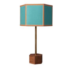 a wooden table lamp with a blue shade on the base and a light green fabric covering