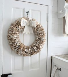 a white door with a wreath hanging on it