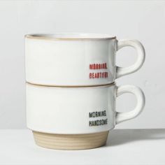 two coffee mugs stacked on top of each other with the words morning handsome written on them