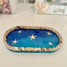 a blue tray with stars on it sitting on a white table next to other items