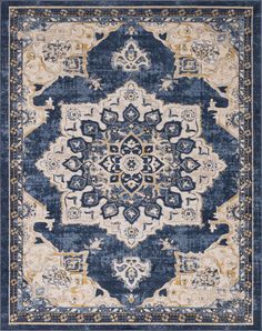 a blue and beige rug with an ornate design on the center, in front of a white background