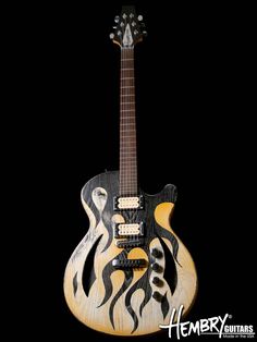 an electric guitar with flames painted on it's body and neck, against a black background