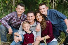 a family posing for a photo in the grass