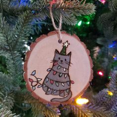 a wooden ornament with a cat wearing a crown