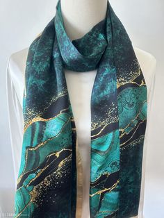 Vibrant and colorful natural mulberry silk long scarf with customized size of 170 cm x 55 cm / 68 in x 22 in. Gorgeous, velvety turquoise print, embellished with dreamy golden-copper streaks. One sided print, smooth and lustrous silk charmeuse, breathable and skin-friendly fabric feels very comfortable to wear. soft and lustrous fabric, light weight,breathable and skin-friendly feels very comfortable to wear. Can style this long scarf in different ways: wear the scarf as a neck scarf, as a long hair scarf, as a head wrap scarf, as an evening cover up...or style it any way you want with your own sense of creativity! Suitable for all seasons and a lovely gift idea for special occasions. Care Instructions: Pure silk is a type of organic, natural, and delicate fabric, please avoid washing. Dry Green Silk Scarf For Party, Green Shawl Scarf For Festive Occasions, Green Shawl Scarves For Festive Occasions, Green Festive Shawl Scarf, Artistic Green Silk Scarf As A Gift, Green Shawl Scarf As Gift, Green Rectangular Scarf As Gift, Elegant Multicolor Silk Scarf For Festive Occasions, Green Rectangular Scarf For Gift