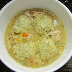 a white bowl filled with soup and dumplings