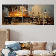 a living room with couches and paintings on the wall