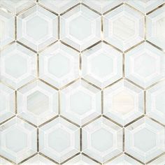 a white tiled wall with hexagonal tiles