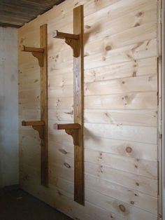 a wooden wall with some shelves on it and one shelf is made out of wood