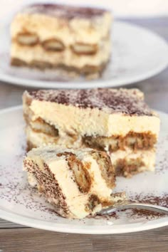 two pieces of cake sitting on top of a white plate with a fork in it