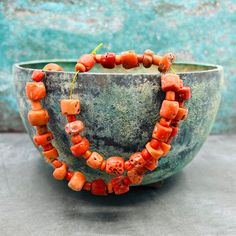 A stunning strand of antique coral beads at a very good prize! These lmatching mediterranean coral beads are a must have for your tribal and ethnic jewelry projects! Last picture gives some inspiration! For more sets and strand, click here: https://creatoriq.cc/3DZZXNZ ✔️ Shape: corn and small tube beads ✔️ Weight: 45 grams ✔️ Size bead: 4-10 mm, diameter 5-12 mm ✔️ Total length: ca 42 cm ✔️ Temporarily strung ✔️ Origin: Mediterranean Sea ✔️ Condition: very good, consistent with age and use ✔️ T Traditional Coral Gemstone Beads, Coral Bohemian Polished Beads, Orange Bohemian Red Coral Beads, Bohemian Orange Red Coral Beads, Bohemian Coral Gemstone Beads, Bon Prix, Coral Jewelry, Unique Bracelets, Coral Beads