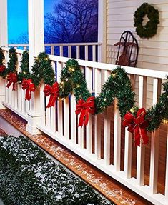 christmas wreaths on the front porch decorated with lights