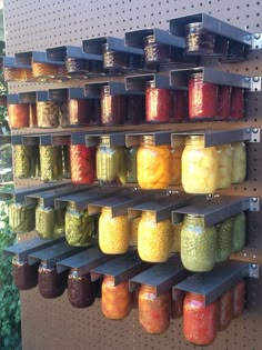 the shelves are filled with many different types of pickles and other food in jars