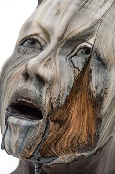 a close up of a statue of a man with his mouth open