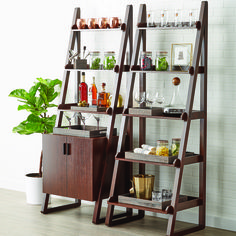 two wooden shelves with bottles and glasses on them