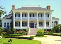 a large white house with many windows and balconies