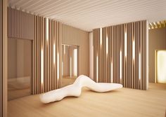 a room with wooden slats on the walls and a white sculpture in the middle