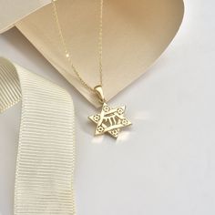 "With this stunning 14K Solid Gold Star of David Chai Pendant, you'll shine like a star. This stunning 18K Jewish Identity David Star Necklace is a timeless representation of life and tradition. This pendant is made of exquisite pure gold and includes a delicate six-pointed star carved with detailed embellishments. The Hebrew word \"life\" is represented by the chai sign in the center, making this a memorable gift for any occasion. Whether you're honoring your faith or reconnecting with your heritage, this beautiful necklace's basic yet elegant design will enhance any look. Give the gift of tradition this holiday season with this handcrafted piece of Jewish jewelry. Details of the product Material: 14K and 18K Solid Gold Elegant Gift For people whom you love; Mom, Girlfriend, Wife, Fiance, Gold Star Of David Jewelry For Anniversary, Classic Star Of David Jewelry For Anniversary, Classic Star Of David Jewelry For Gift, 14k Gold Star Of David Necklace For Anniversary, Gold Star Of David Necklace For Anniversary, 14k Gold Star Of David Jewelry For Anniversary, 14k Gold Star Of David Necklace Engraved, Gold Star Necklace For Anniversary, 14k Gold Star-shaped Necklace For Anniversary