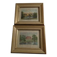 two framed paintings of houses and trees in gold frames