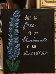 a painted sign with the words she's as free as the bluebonnets in the summer