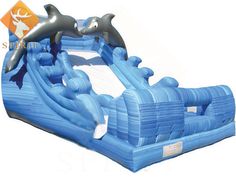 an inflatable water slide with two dolphins on it