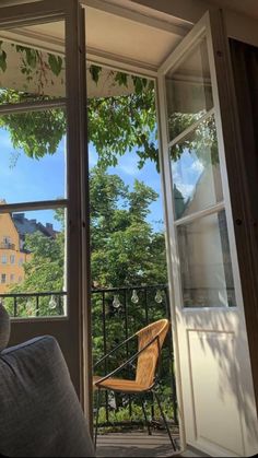 an open door leading to a balcony with a chair