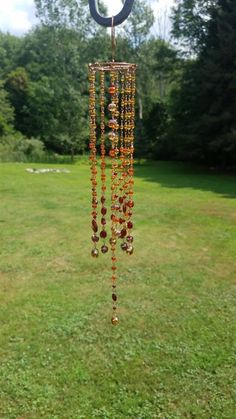 a wind chime hanging in the middle of a field