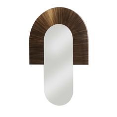 a mirror that is sitting on top of a wooden shelf with an arch shaped mirror above it