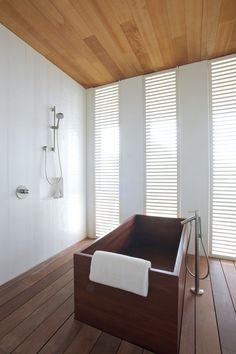 a bath tub sitting on top of a wooden floor