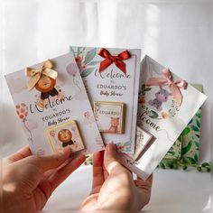 a person holding up some cards with animals on them and bows around their necks,