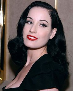 a woman with black hair and red lipstick