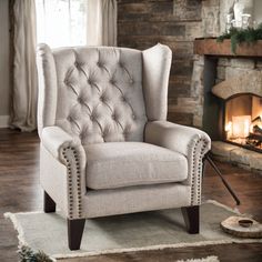 a living room with a fire place and a chair in front of the fireplace,