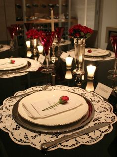 a table set with place settings and candles