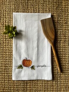 a wooden spoon sitting on top of a white napkin